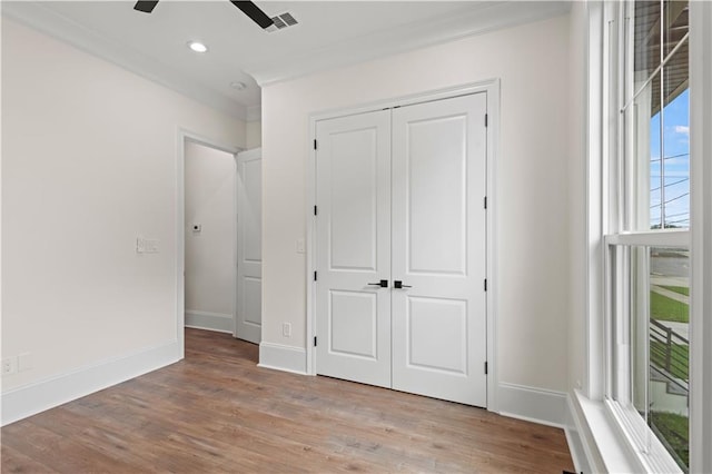 2104 Mississippi Ave, Metairie, LA 70003 - unfurnished bedroom with ornamental molding, light wood-style flooring, a closet, baseboards, and recessed lighting