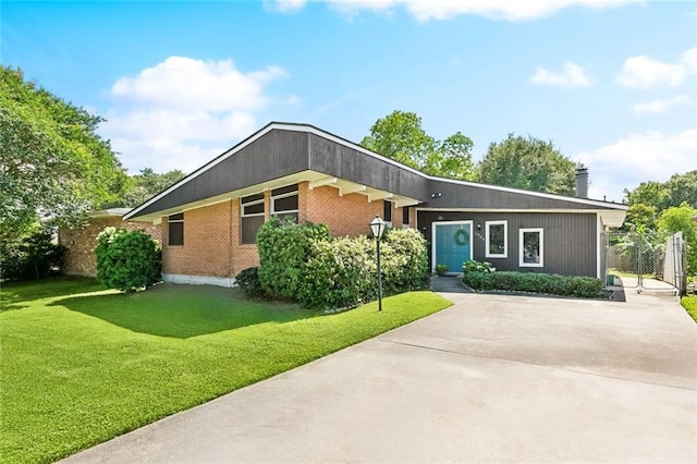 view of front of home with brick siding and a chimney