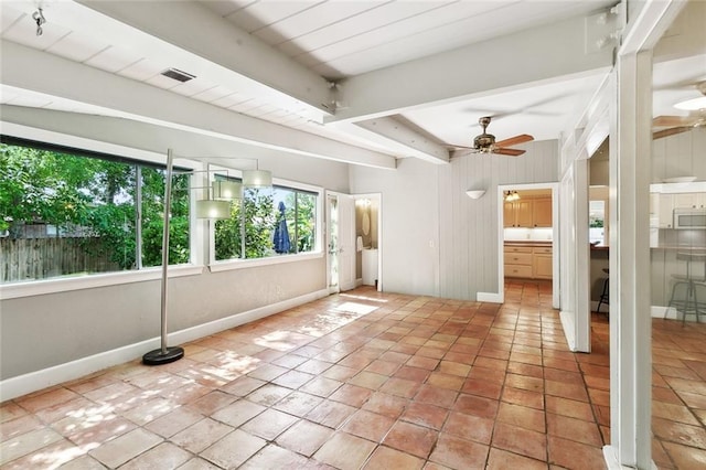 unfurnished sunroom with beamed ceiling