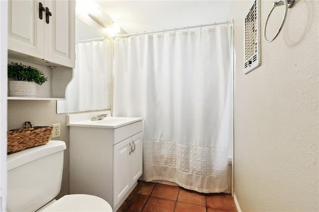 bathroom with toilet, tile patterned flooring, vanity, and curtained shower
