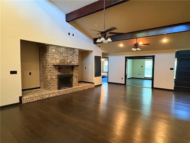 11240 Winrock Dr, New Orleans, LA 70128 - unfurnished living room featuring beamed ceiling, a ceiling fan, a brick fireplace, wood finished floors, and baseboards