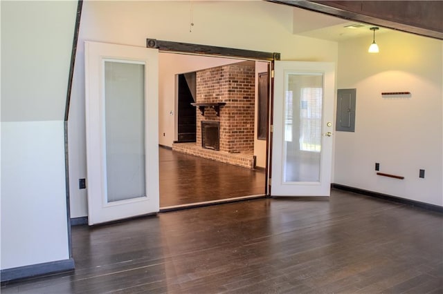 11240 Winrock Dr, New Orleans, LA 70128 - spare room featuring electric panel, wood finished floors, a brick fireplace, and baseboards
