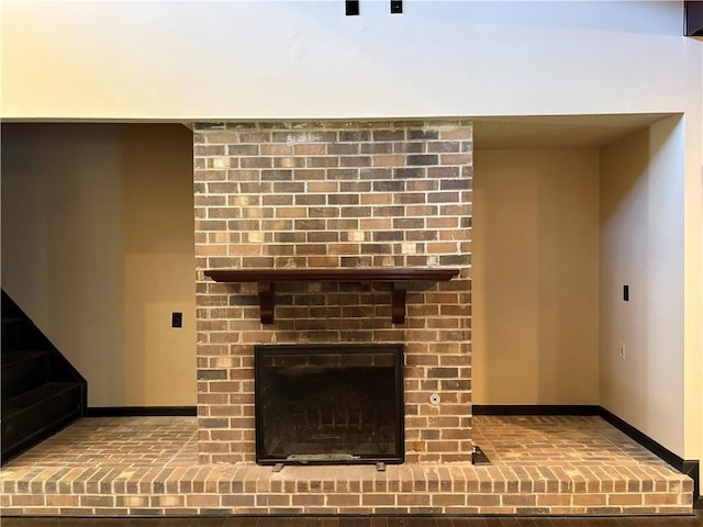 11240 Winrock Dr, New Orleans, LA 70128 - detailed view of baseboards and a brick fireplace
