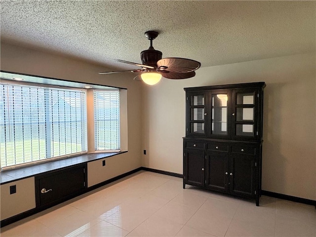 11240 Winrock Dr, New Orleans, LA 70128 - empty room featuring a ceiling fan, baseboards, and a textured ceiling