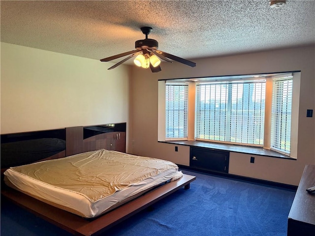 11240 Winrock Dr, New Orleans, LA 70128 - bedroom featuring carpet flooring, a textured ceiling, baseboards, and a ceiling fan