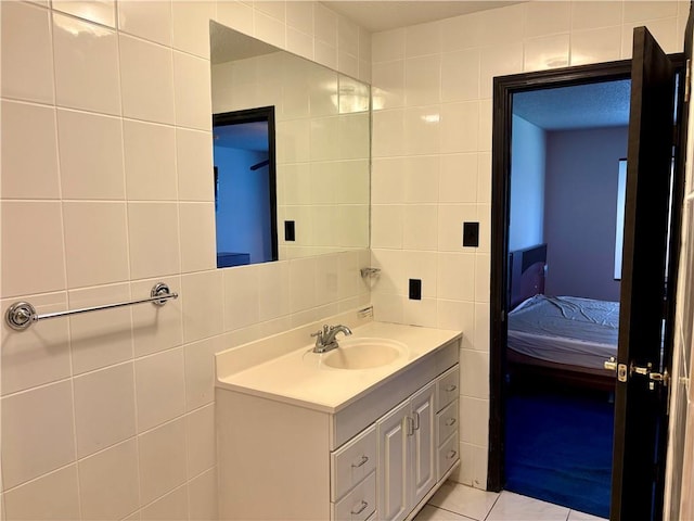 11240 Winrock Dr, New Orleans, LA 70128 - bathroom with tile walls, vanity, connected bathroom, and tile patterned flooring