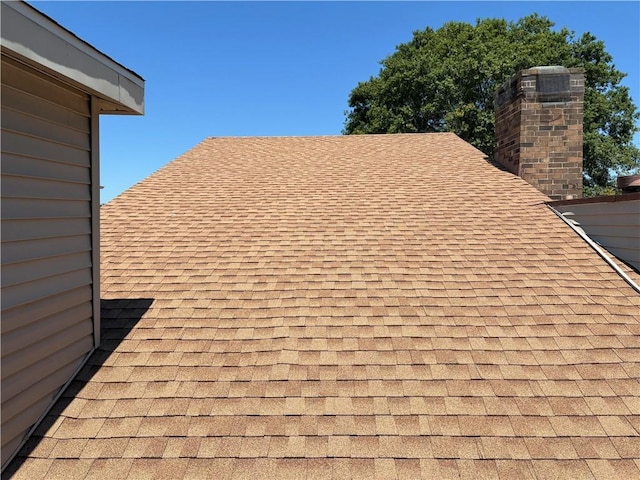 11240 Winrock Dr, New Orleans, LA 70128 - exterior view of roof with shingles and a chimney