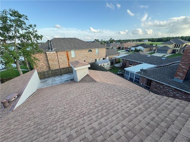 11240 Winrock Dr, New Orleans, LA 70128 - exterior view of roof with shingles and a residential view