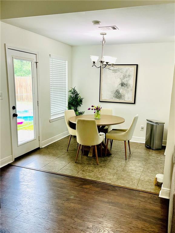 40081 Bismark St, Ponchatoula, LA 70454 - dining space featuring a chandelier, wood finished floors, and baseboards