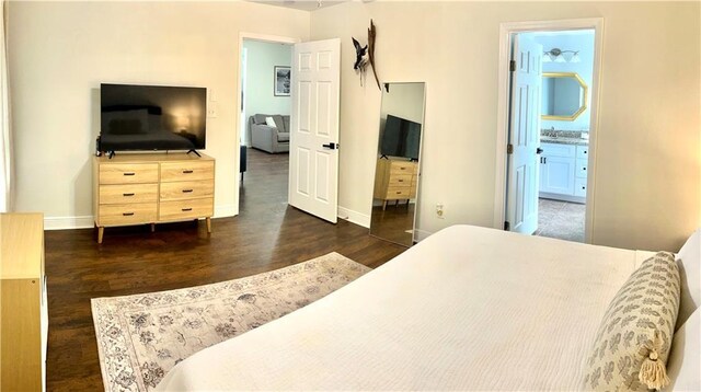 40081 Bismark St, Ponchatoula, LA 70454 - bedroom featuring wood finished floors, baseboards, and connected bathroom