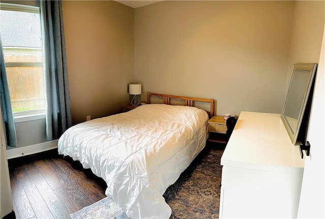 40081 Bismark St, Ponchatoula, LA 70454 - bedroom with multiple windows, dark wood finished floors, and baseboards