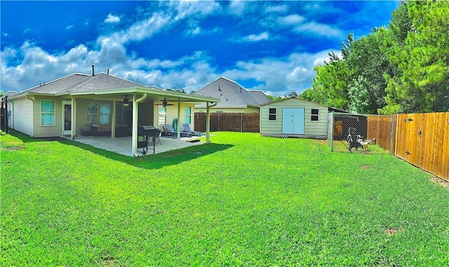 40081 Bismark St, Ponchatoula, LA 70454 - rear view of property featuring ceiling fan, a patio area, a storage shed, and an outbuilding