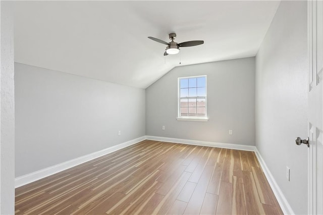bonus room with ceiling fan, vaulted ceiling, wood finished floors, and baseboards