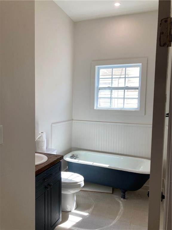 3515 S Miro St, New Orleans, LA 70125 - full bath with vanity, a freestanding bath, toilet, a wainscoted wall, and a decorative wall