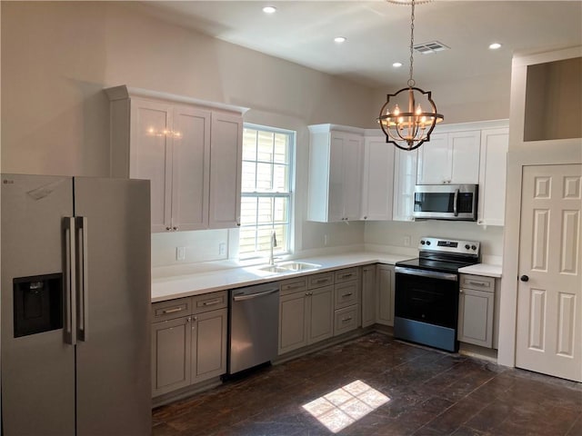 3515 S Miro St, New Orleans, LA 70125 - kitchen featuring stainless steel appliances, a chandelier, a sink, light countertops, and hanging light fixtures