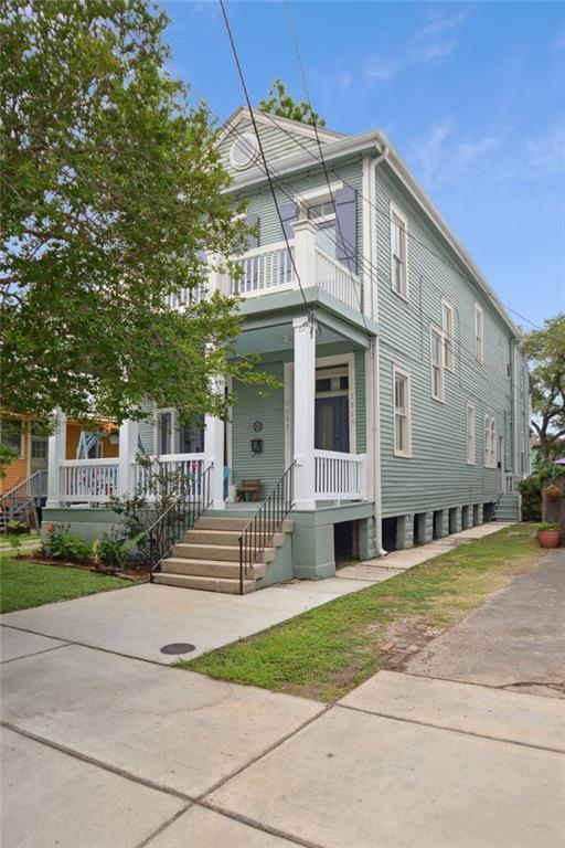 view of front of house with covered porch and a balcony