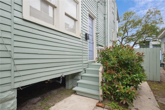 view of side of property featuring fence