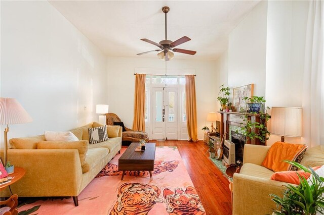living room with ceiling fan and wood finished floors