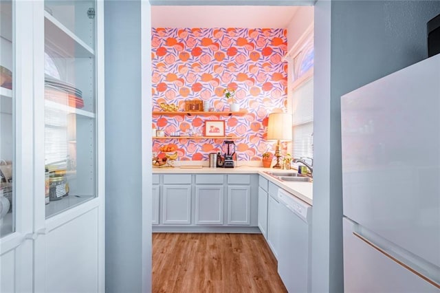 indoor wet bar with white appliances and light wood-type flooring