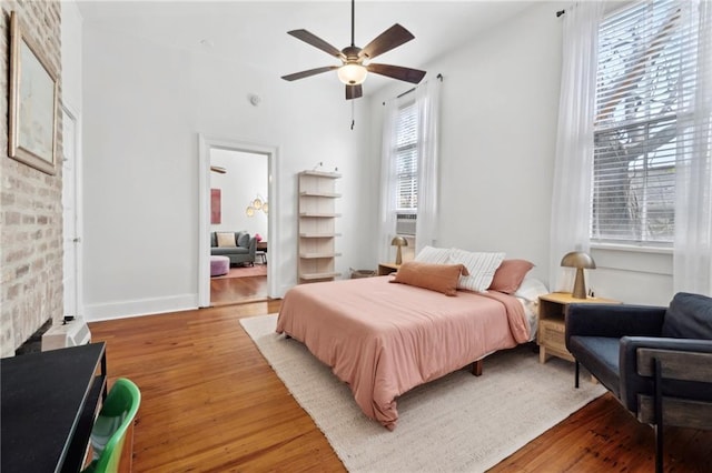 bedroom with light wood-type flooring and ceiling fan