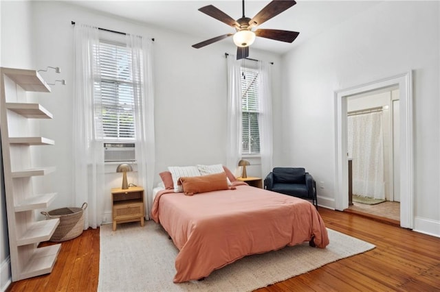 bedroom with wood finished floors, a ceiling fan, and baseboards