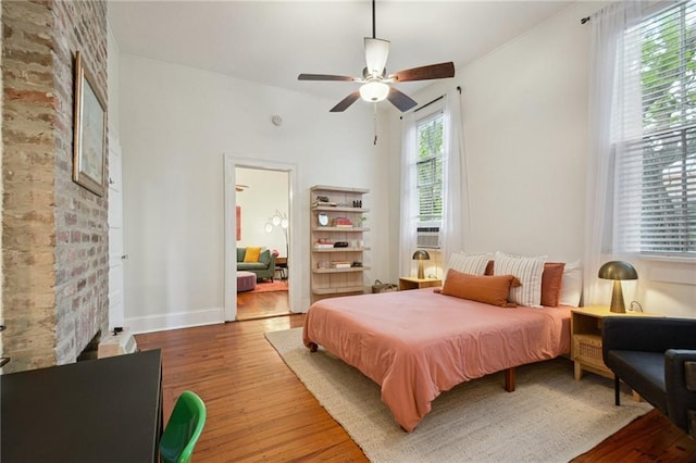 bedroom featuring wood finished floors, ceiling fan, and baseboards