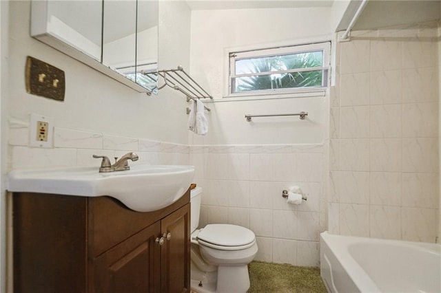 full bath featuring tile walls, toilet, vanity, a wainscoted wall, and shower / bath combination