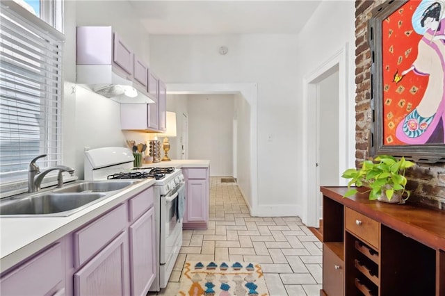 kitchen featuring white gas range oven and a sink