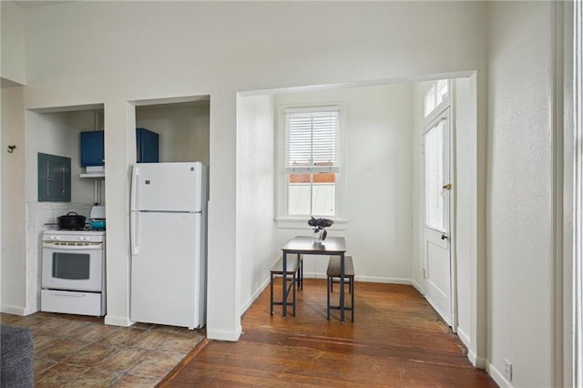 kitchen featuring white appliances, electric panel, healthy amount of natural light, and baseboards