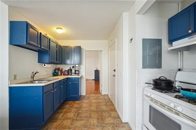 kitchen with white gas range, electric panel, a sink, blue cabinetry, and under cabinet range hood