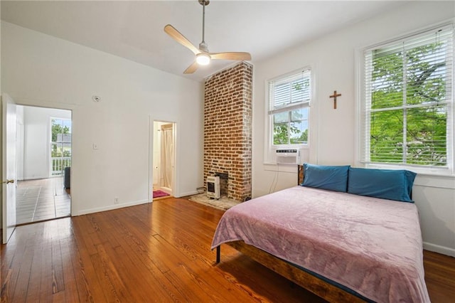 bedroom with hardwood / wood-style floors, baseboards, and a ceiling fan