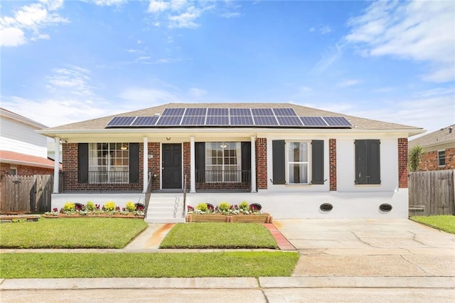 5801 Ruth St, Metairie, LA 70003 - ranch-style house with brick siding, solar panels, a porch, and concrete driveway