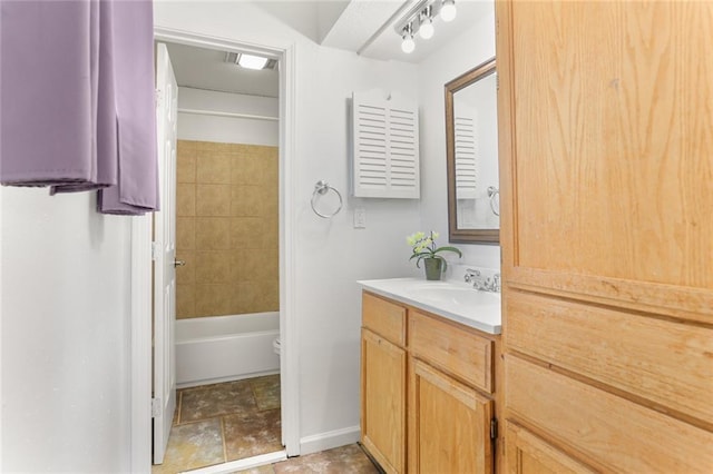 full bathroom with vanity, baseboards,  shower combination, and toilet