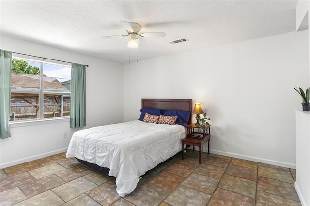 5801 Ruth St, Metairie, LA 70003 - bedroom with a textured ceiling, stone finish floors, and a ceiling fan
