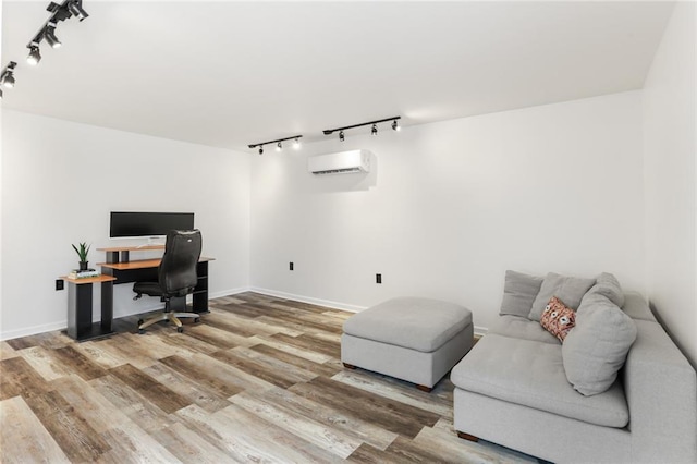 5801 Ruth St, Metairie, LA 70003 - office area featuring rail lighting, a wall mounted air conditioner, and wood finished floors