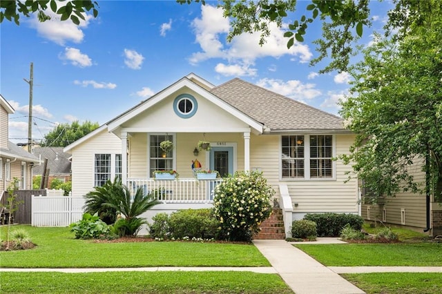 bungalow with covered porch and roof with shingles