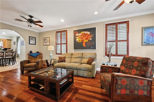 living area featuring a ceiling fan, arched walkways, wood-type flooring, crown molding, and recessed lighting