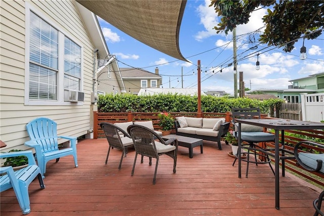 wooden deck featuring a fenced backyard and outdoor lounge area