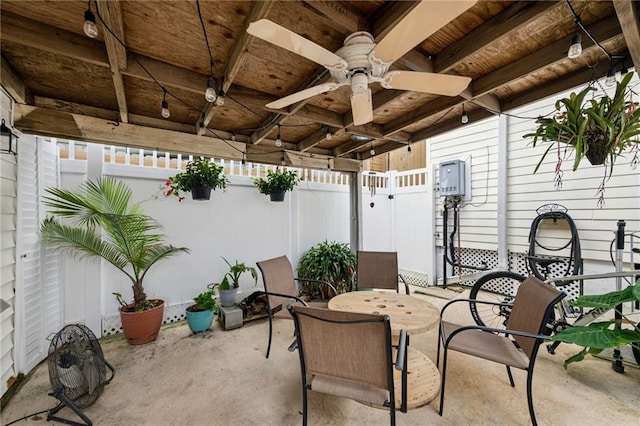 view of patio with outdoor dining area, a fenced backyard, and a ceiling fan