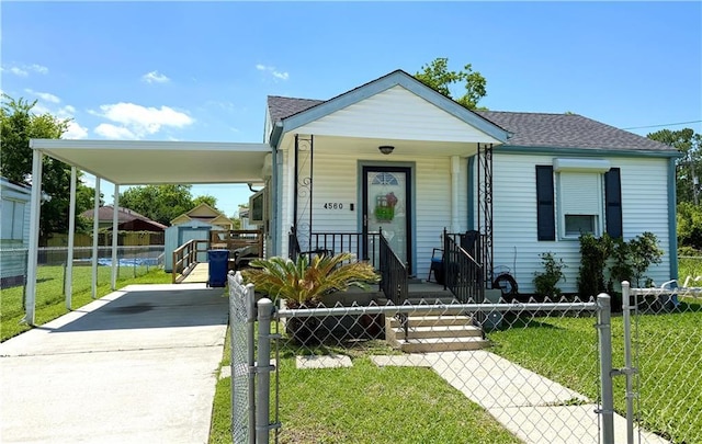 4560 Laine Ave, New Orleans, LA 70126 - shotgun-style home featuring covered porch, driveway, an attached carport, an outbuilding, and a shed