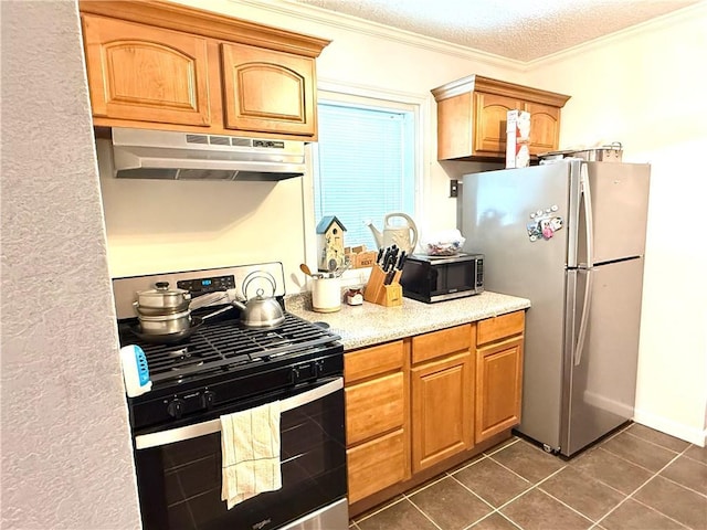 4560 Laine Ave, New Orleans, LA 70126 - kitchen featuring stainless steel appliances, under cabinet range hood, crown molding, dark tile patterned flooring, and a textured ceiling