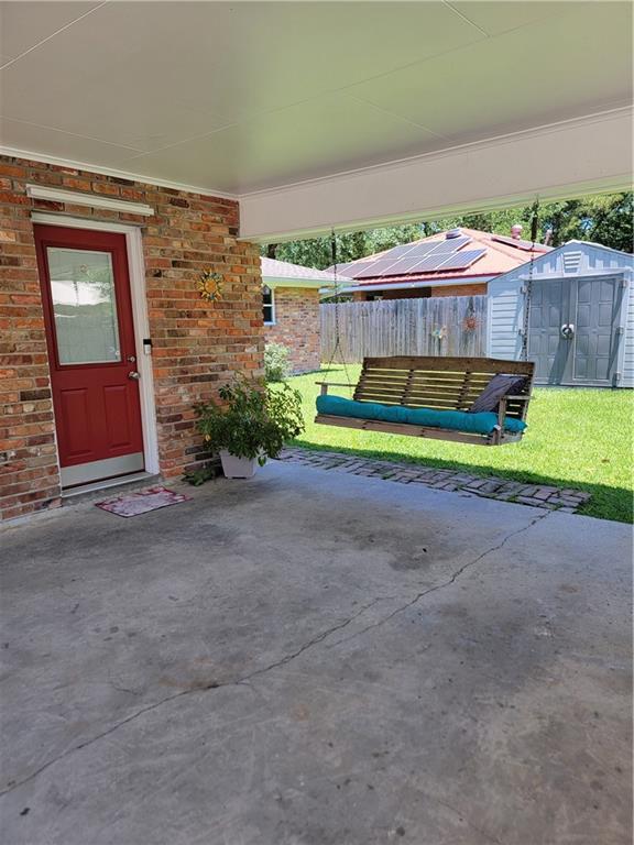 1207 Cousin St, Slidell, LA 70458 - view of patio with a storage unit
