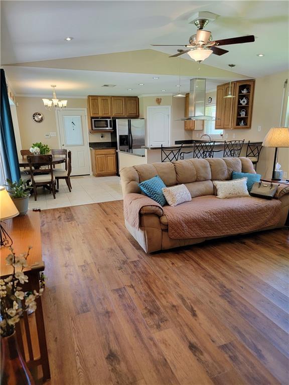 1207 Cousin St, Slidell, LA 70458 - living room featuring a chandelier, light wood-style floors, and a ceiling fan