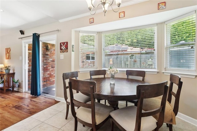 1207 Cousin St, Slidell, LA 70458 - dining space featuring light tile patterned floors, a chandelier, and ornamental molding