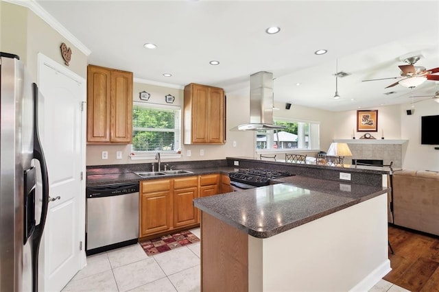 1207 Cousin St, Slidell, LA 70458 - kitchen with stainless steel appliances, range hood, a ceiling fan, healthy amount of natural light, and recessed lighting