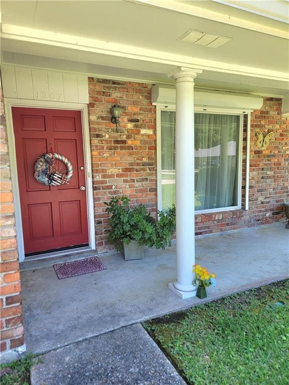 1207 Cousin St, Slidell, LA 70458 - doorway to property with covered porch and brick siding