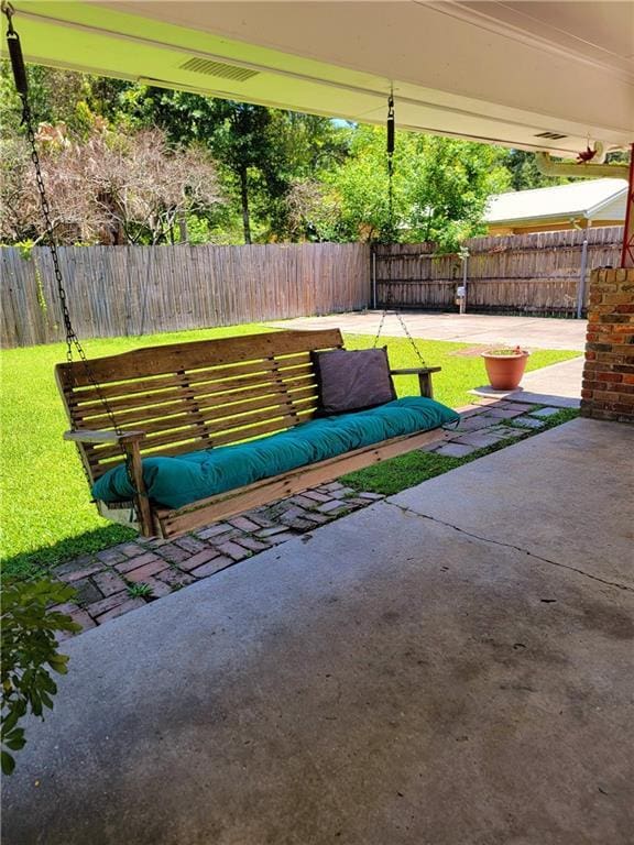 1207 Cousin St, Slidell, LA 70458 - fenced backyard featuring a patio and an outdoor hangout area