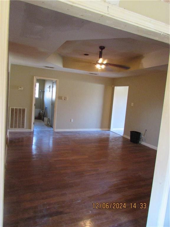 7812 Scottwood Dr, New Orleans, LA 70128 - spare room featuring wood finished floors, a raised ceiling, ceiling fan, and baseboards