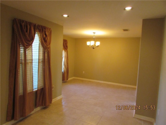 7812 Scottwood Dr, New Orleans, LA 70128 - spare room with a chandelier, recessed lighting, baseboards, and light tile patterned floors