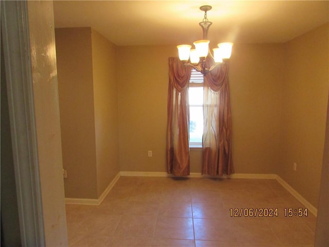 7812 Scottwood Dr, New Orleans, LA 70128 - tiled empty room featuring a chandelier and baseboards